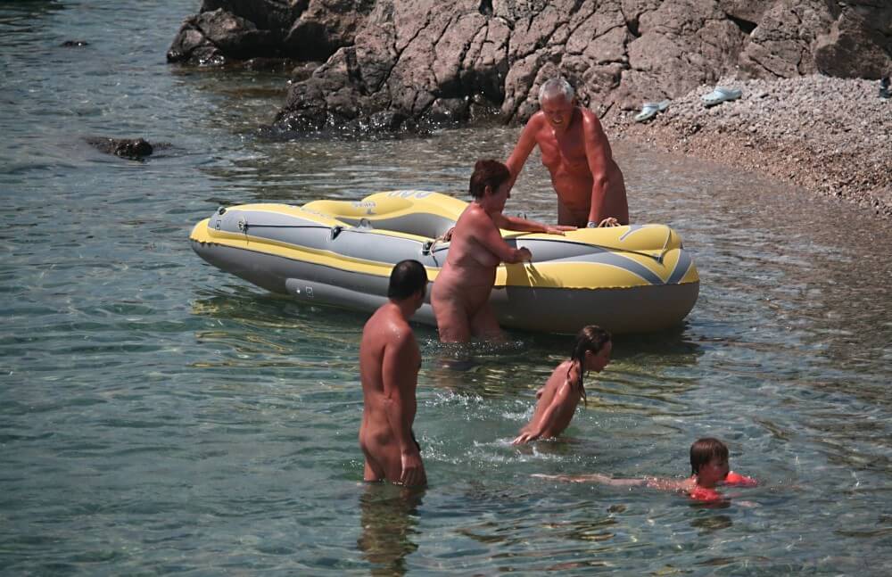 Lone Nudist in Yellow Boat photos - Naturalness requires openness
