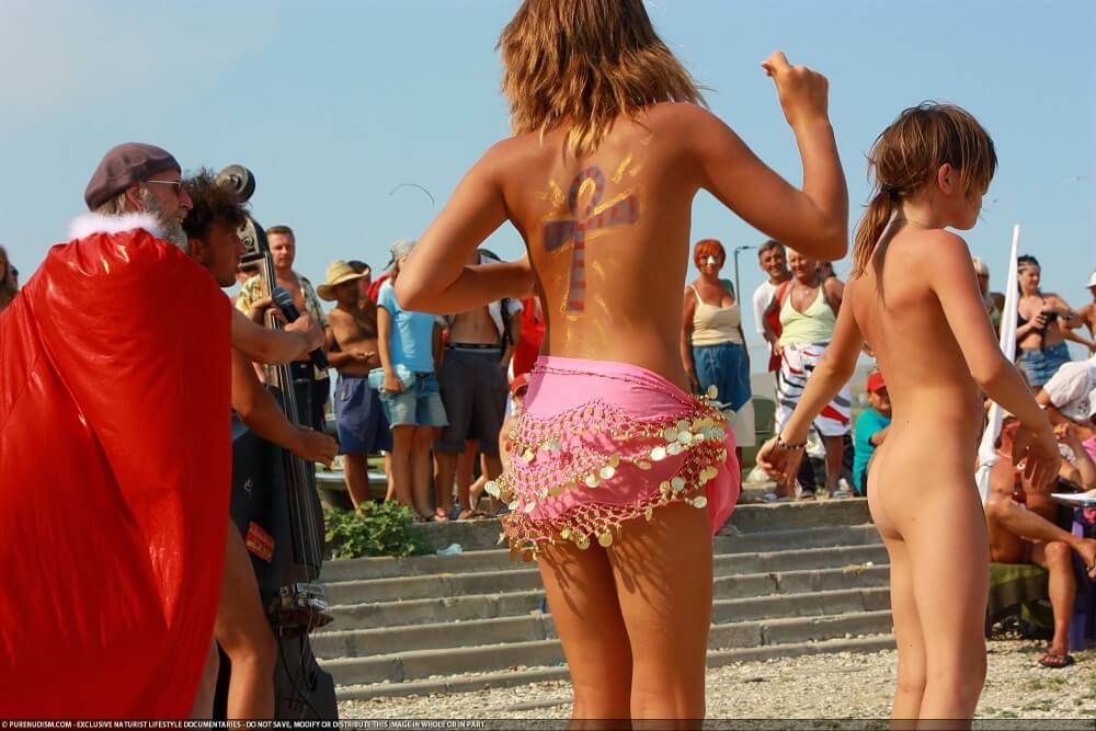 Colorful Carnival Dancing photos - A defining feature of naturism is the absence of clothing